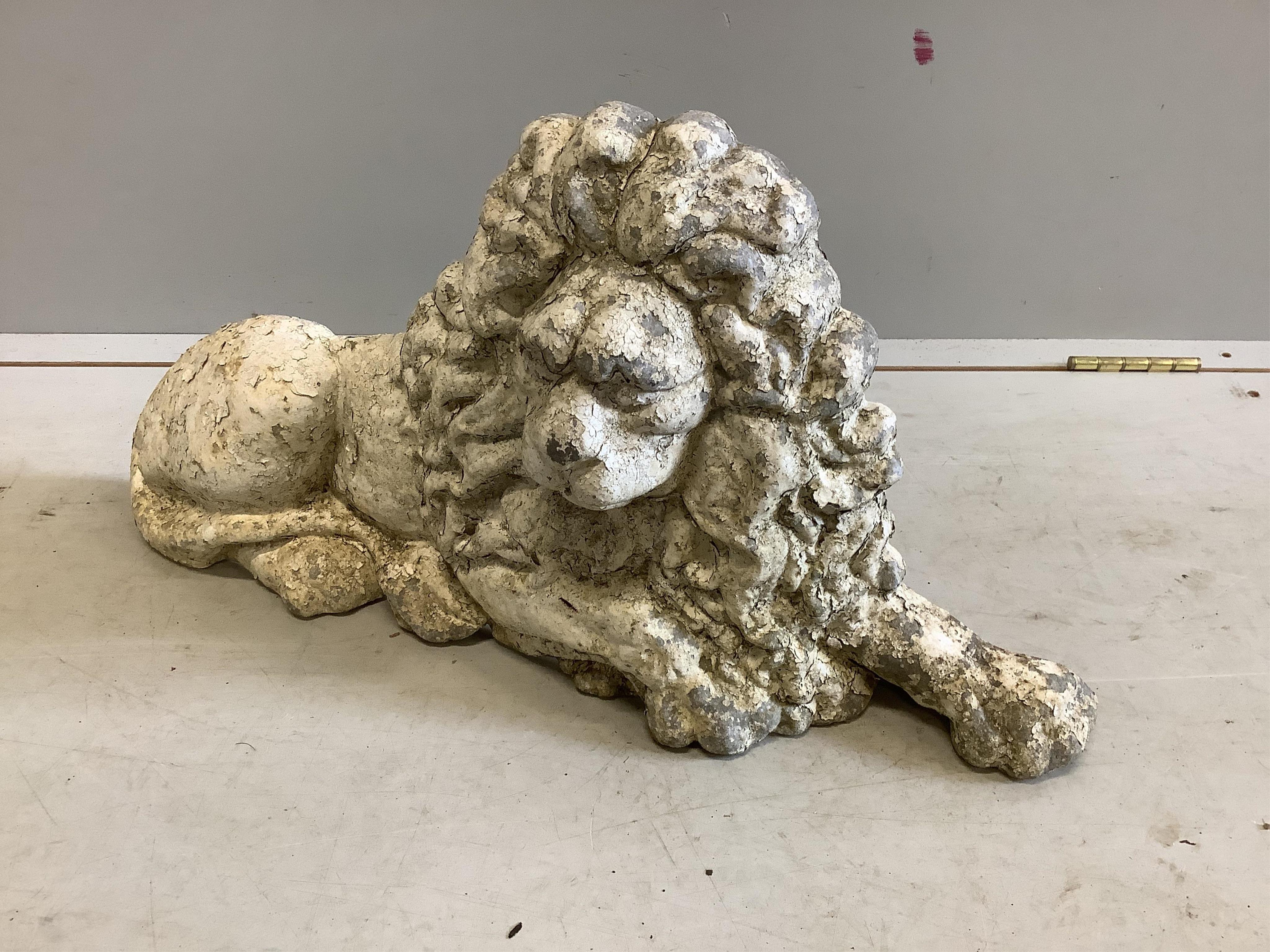 A painted cast aluminium recumbent lion garden ornament, width 66cm, height 35cm. Condition - fair